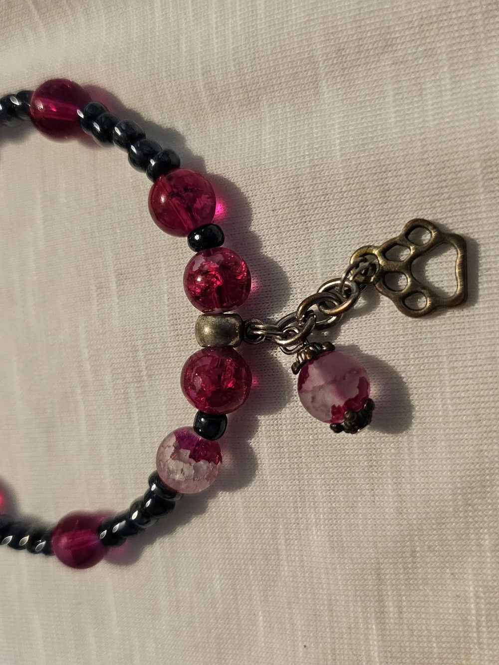 Bright Pink Beaded Bracelet with Dark Accent Beads With Paw Charm